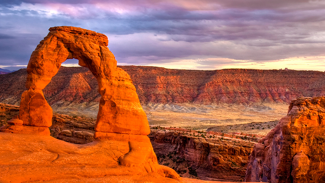 Delicate Arch in Arches National Park on a cloudy day.