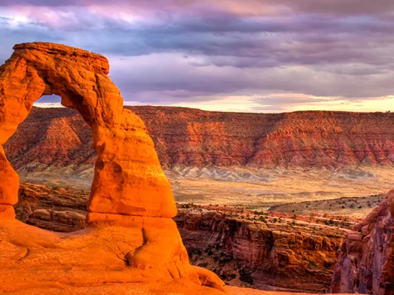 Delicate Arch in Arches National Park on a cloudy day.