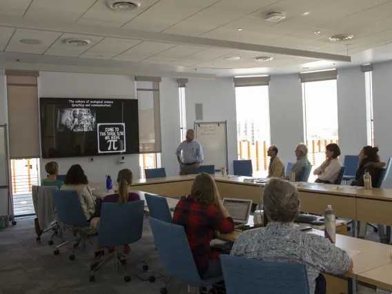 A man giving a presentation to a room of people.