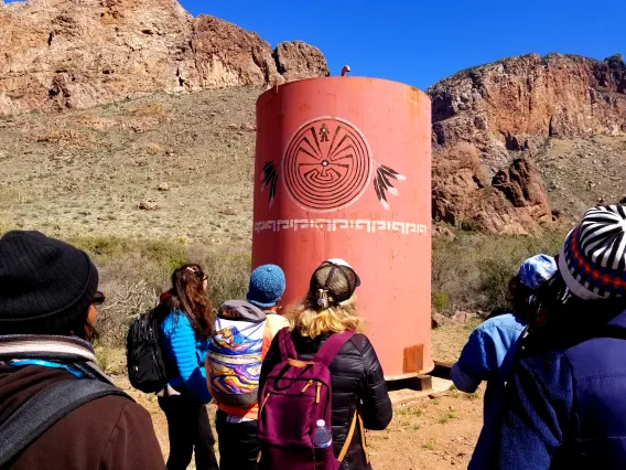 Researchers looking at a water collection unit in the desert.