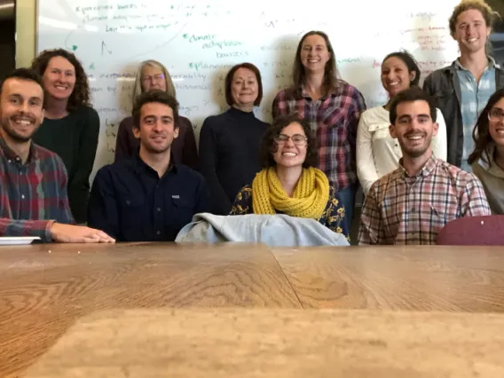 The 2019 group of NRWD fellows sitting at a conference room table posing for a group photo.