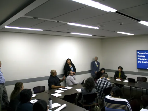 People in a conference room having a discussion.