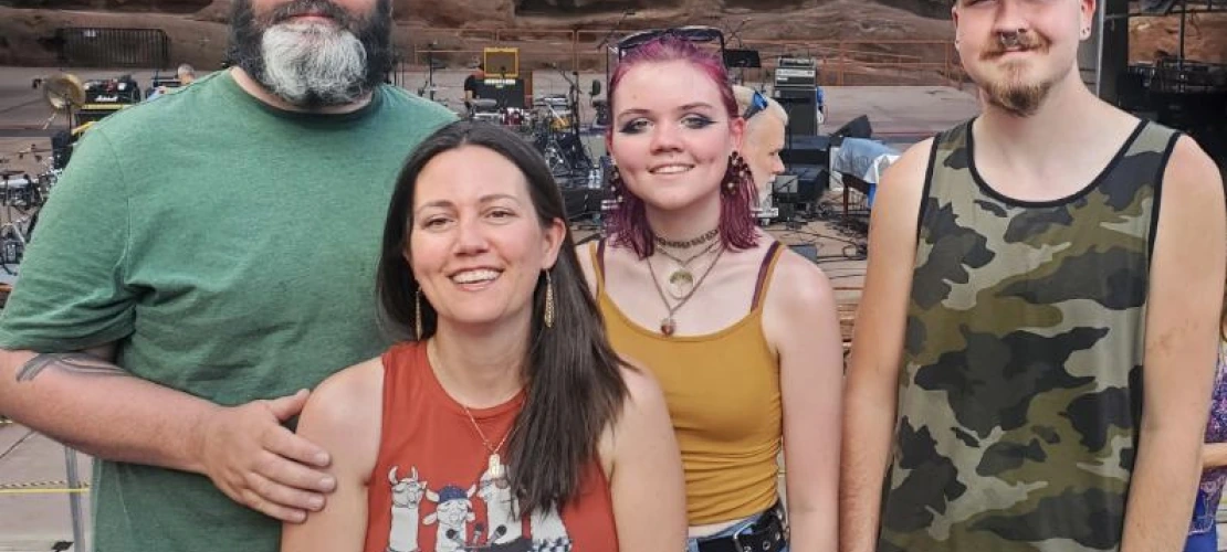 Nicole pictured with friends in front of concert stage