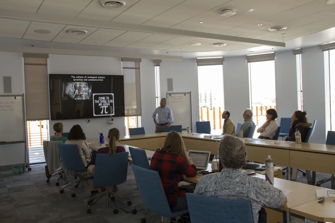 A man giving a presentation to a room of people.