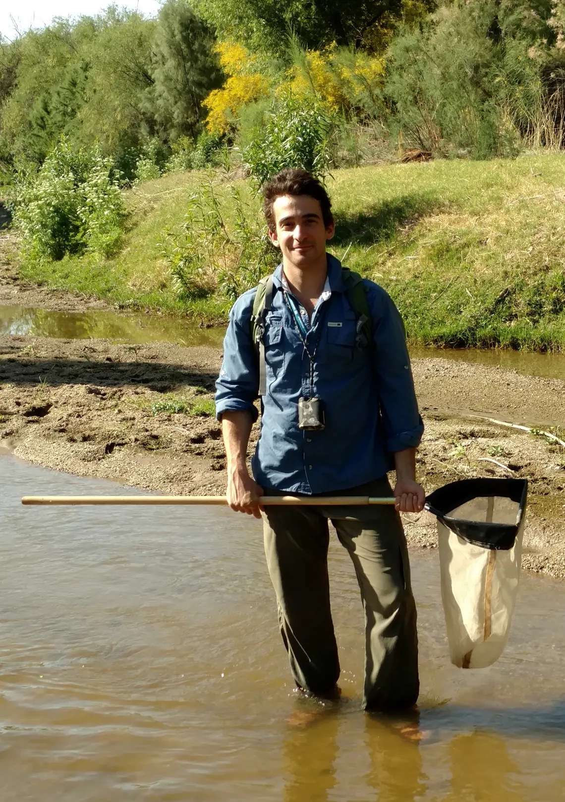 Drew Eppehimer in a river with a net.