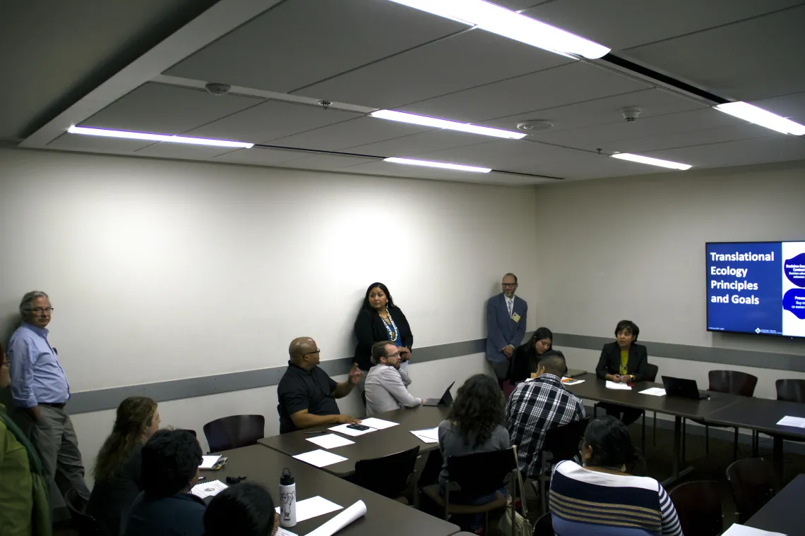 People in a conference room having a discussion.