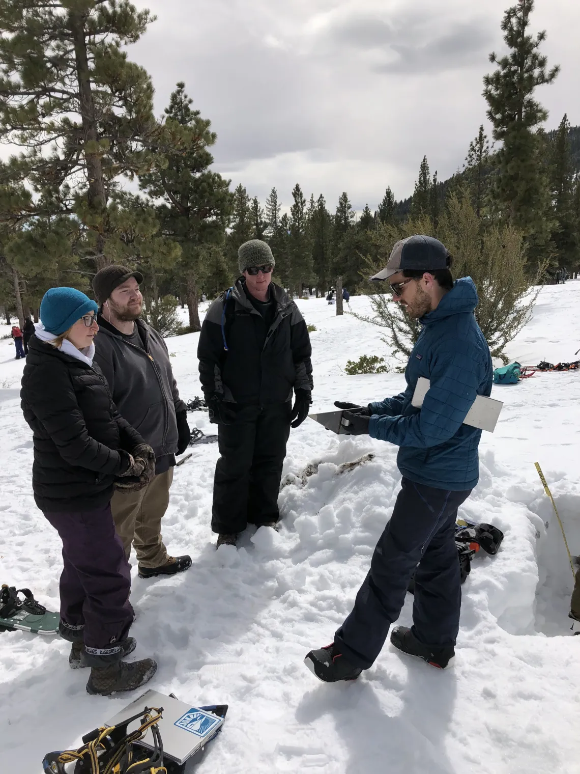 Josh Sturtevant talking to other researchers in the snow