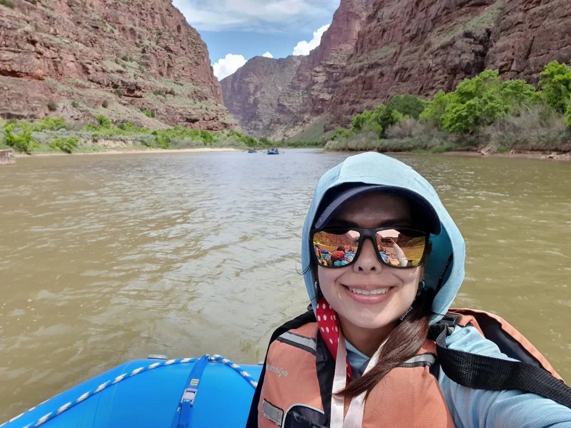 Gabriela T. Sancho Juárez on the river with a lifejack and blue raft