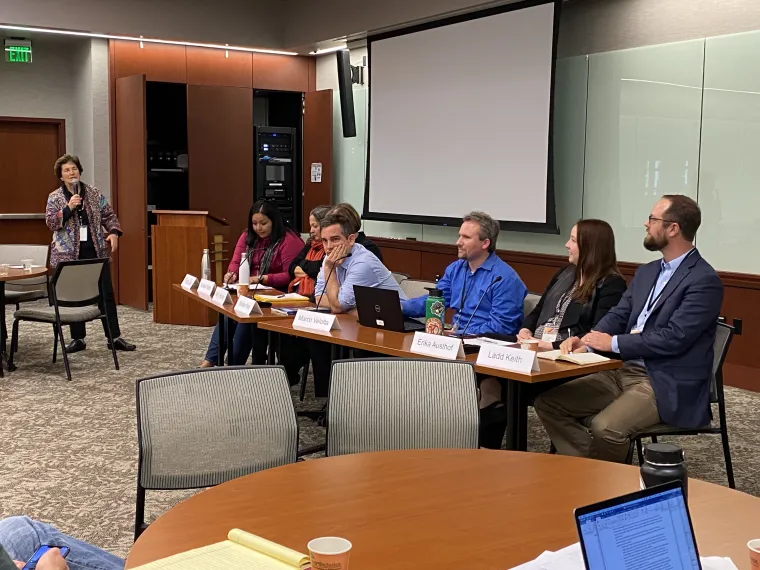 Panel judges sitting behind a table with name cards in front of them.