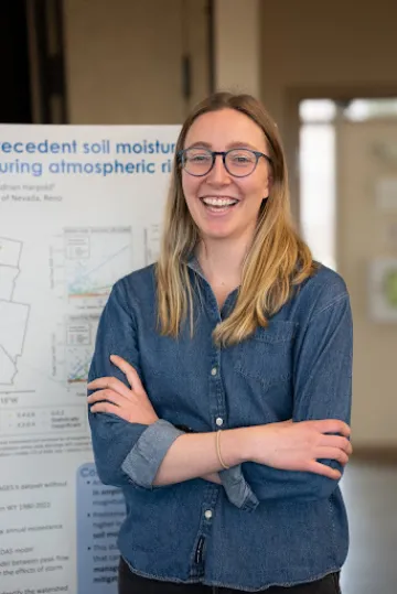 Mariana Webb in front of research posterboard 