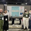 A group of four SWCASC NRWD Fellows stands side by side, smiling and posing in front of their research poster at the AGU 2024 conference.